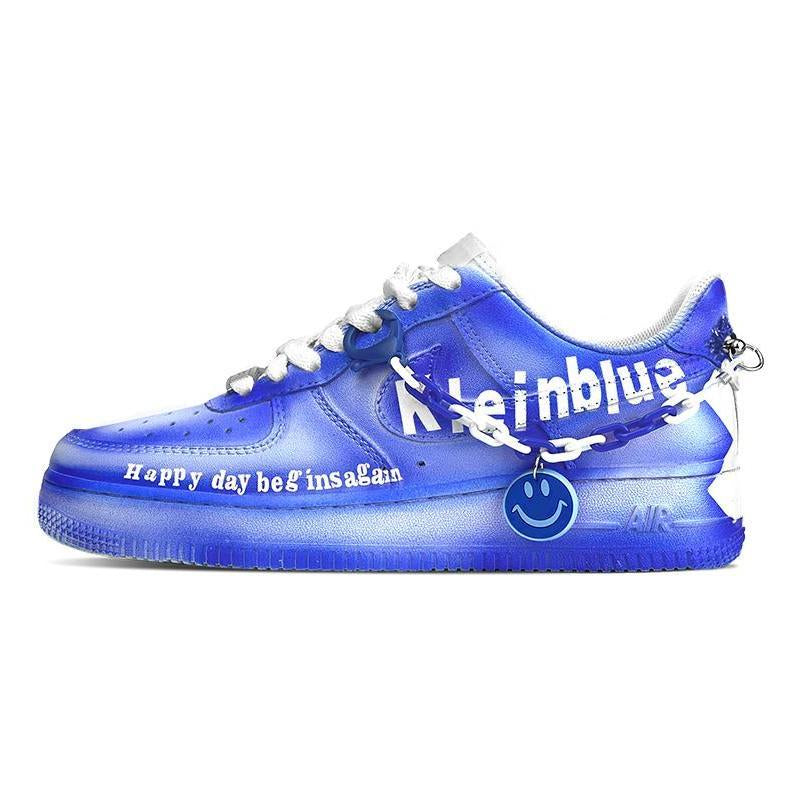 Royal blue graphic custom sneakers with smiley charm